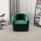 Modern green velvet armchair in living room with neutral decor and bookshelf
