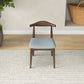 Mid-century modern wooden dining chair with light grey cushion on a rug, FredCo furniture