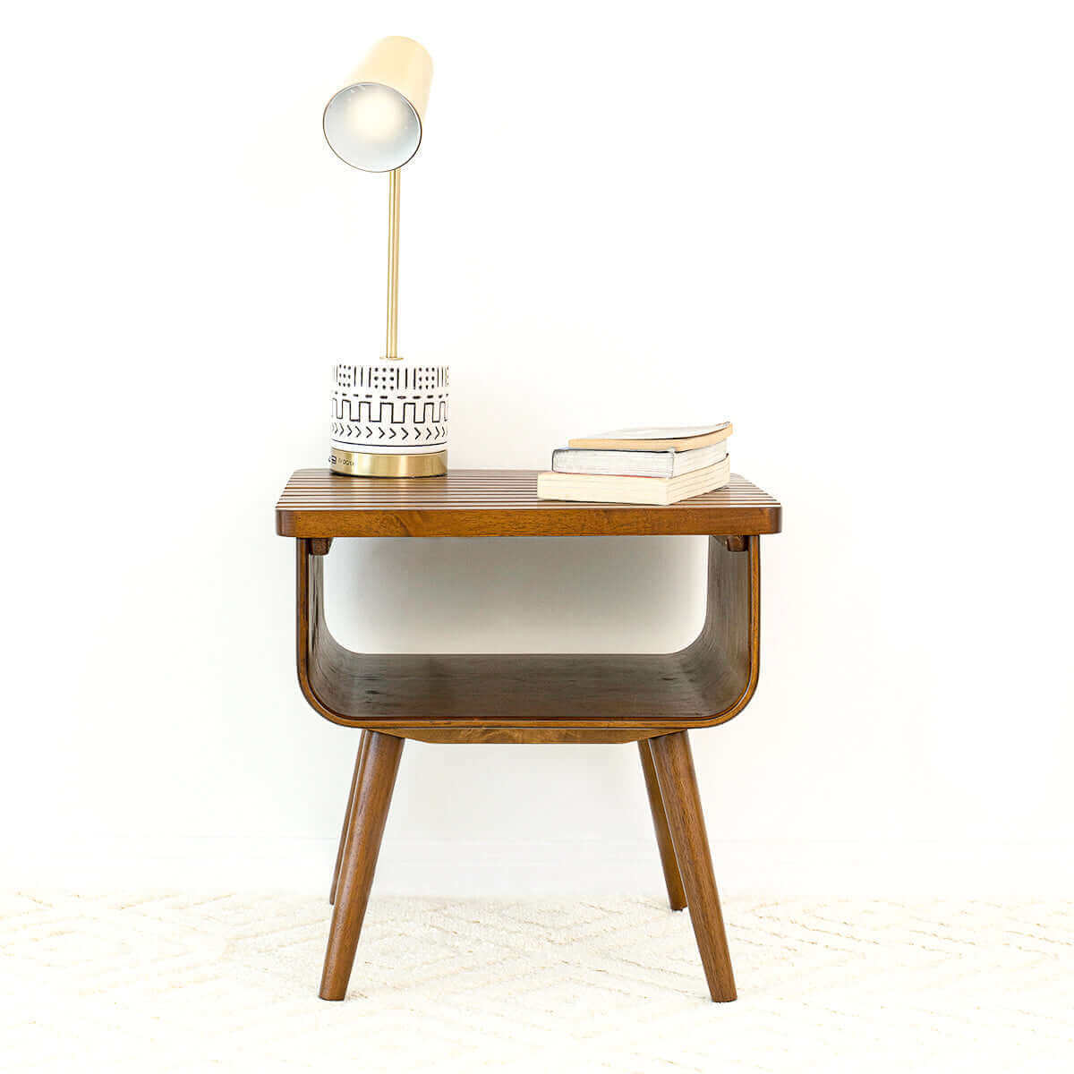 Mid-century modern wooden side table with lamp and books, FredCo International furniture