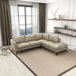 Modern beige sectional sofa in bright living room with large window and minimalist decor