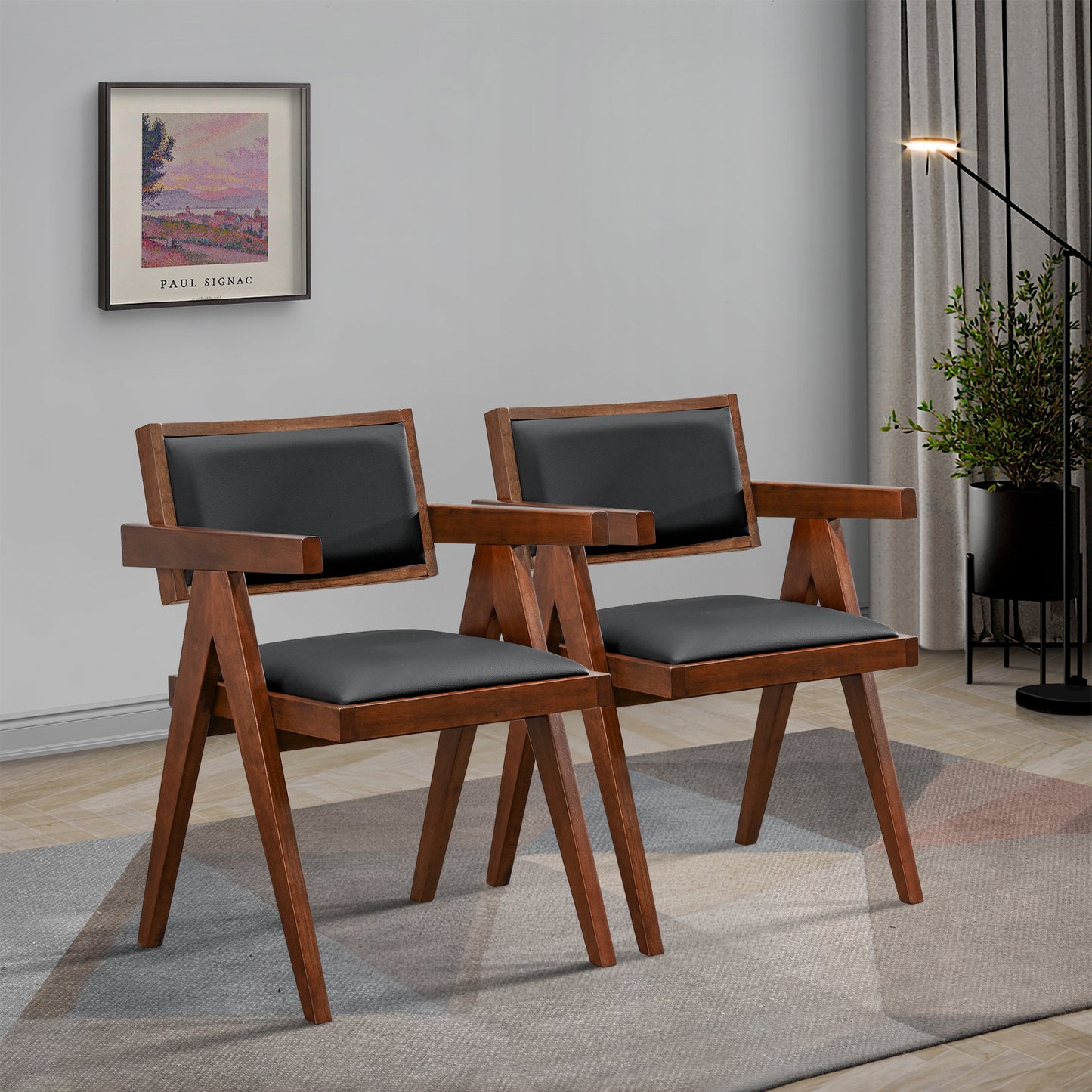 Pair of modern wooden armchairs with black cushions in stylish living room setting