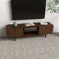 Mid-century modern wood TV stand with drawers, decor vase, and books in living room