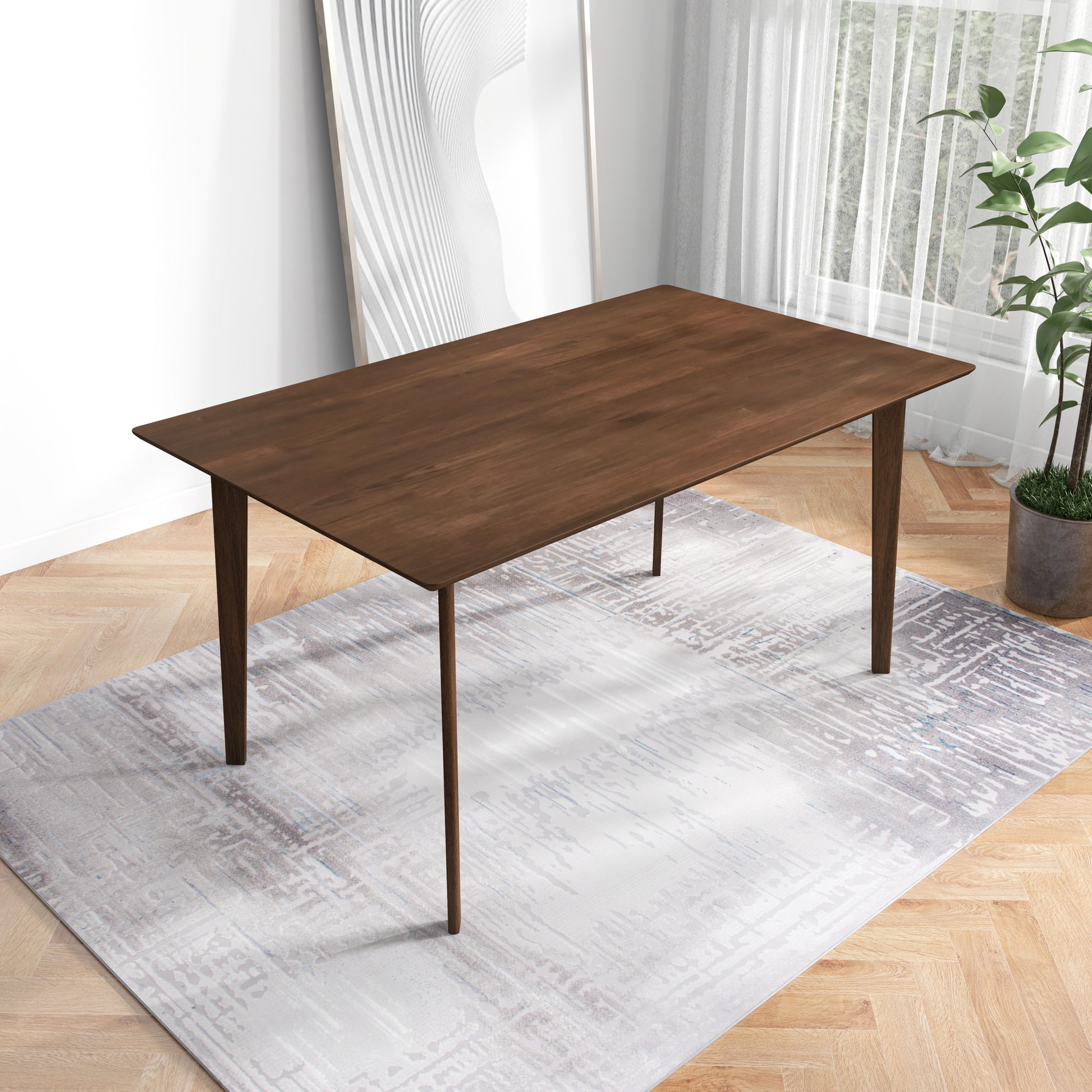 Modern wooden dining table on patterned rug, bright room with plant and artwork, FredCo furniture
