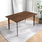 Modern wooden dining table on patterned rug, bright room with plant and artwork, FredCo furniture