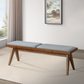 Modern wooden bench with gray cushion in a bright living room, FredCo International furniture