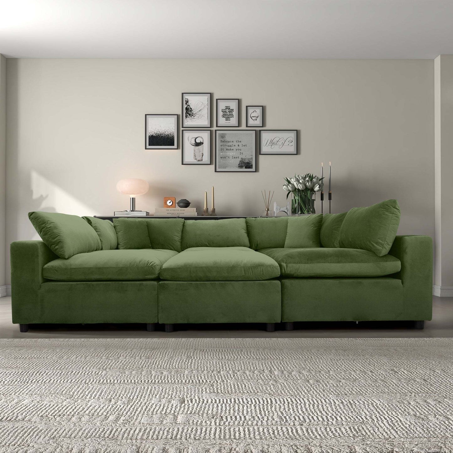 Modern living room with green sectional sofa, neutral wall art, and textured beige rug