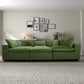 Modern living room with green sectional sofa, neutral wall art, and textured beige rug