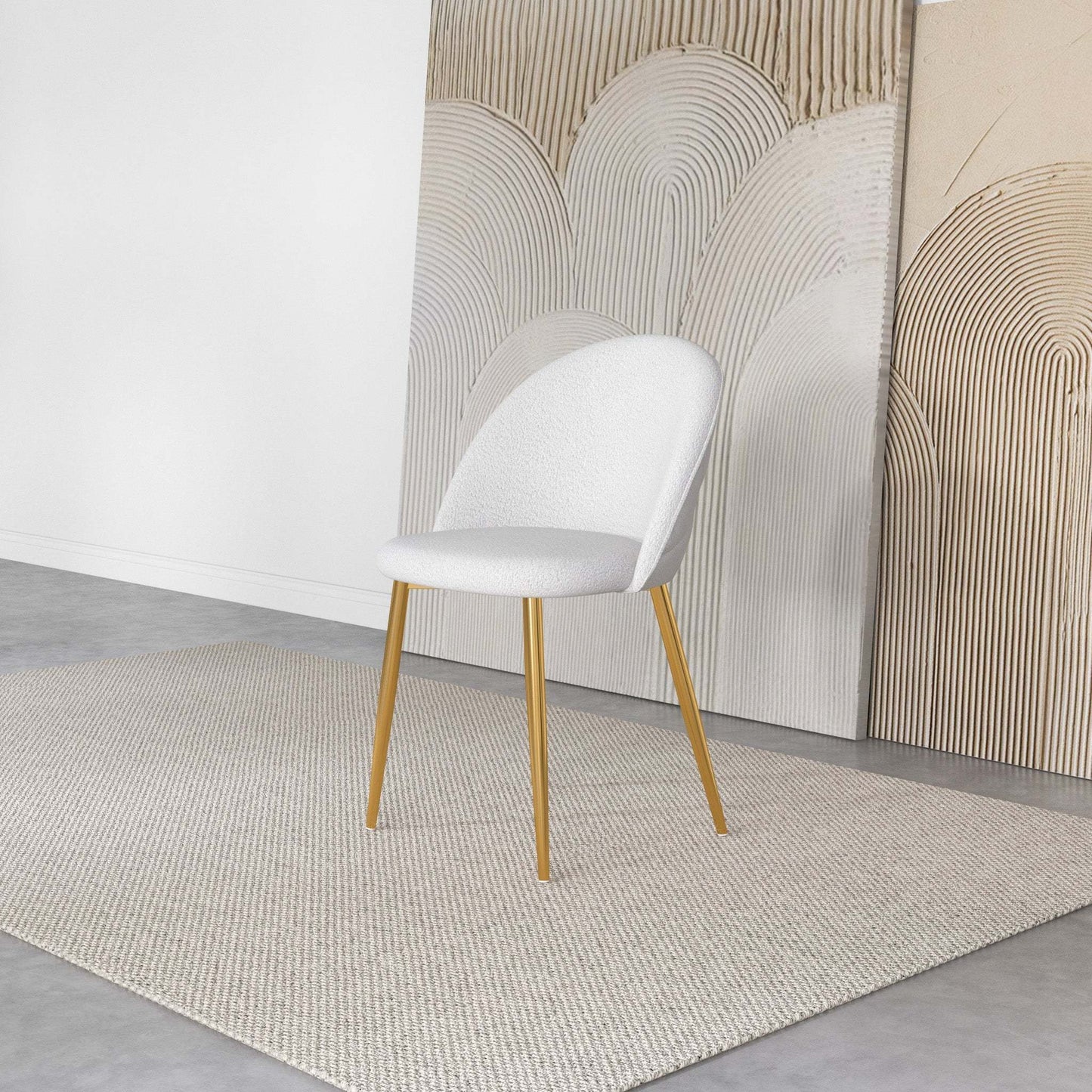 Modern white accent chair with gold legs on beige rug, abstract art background, FredCo International