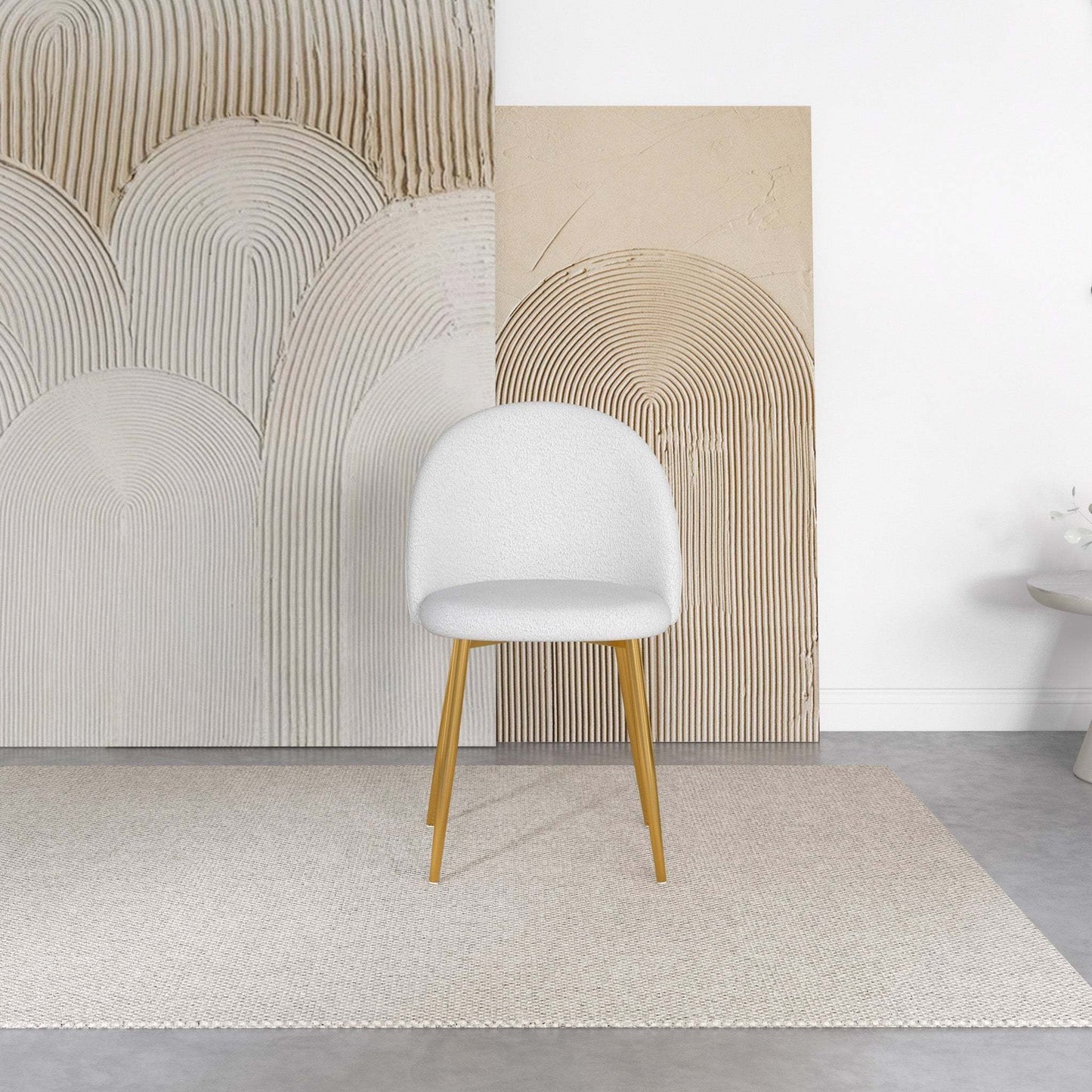 Modern white accent chair with wood legs on a beige rug, abstract wall art background, FredCo furniture