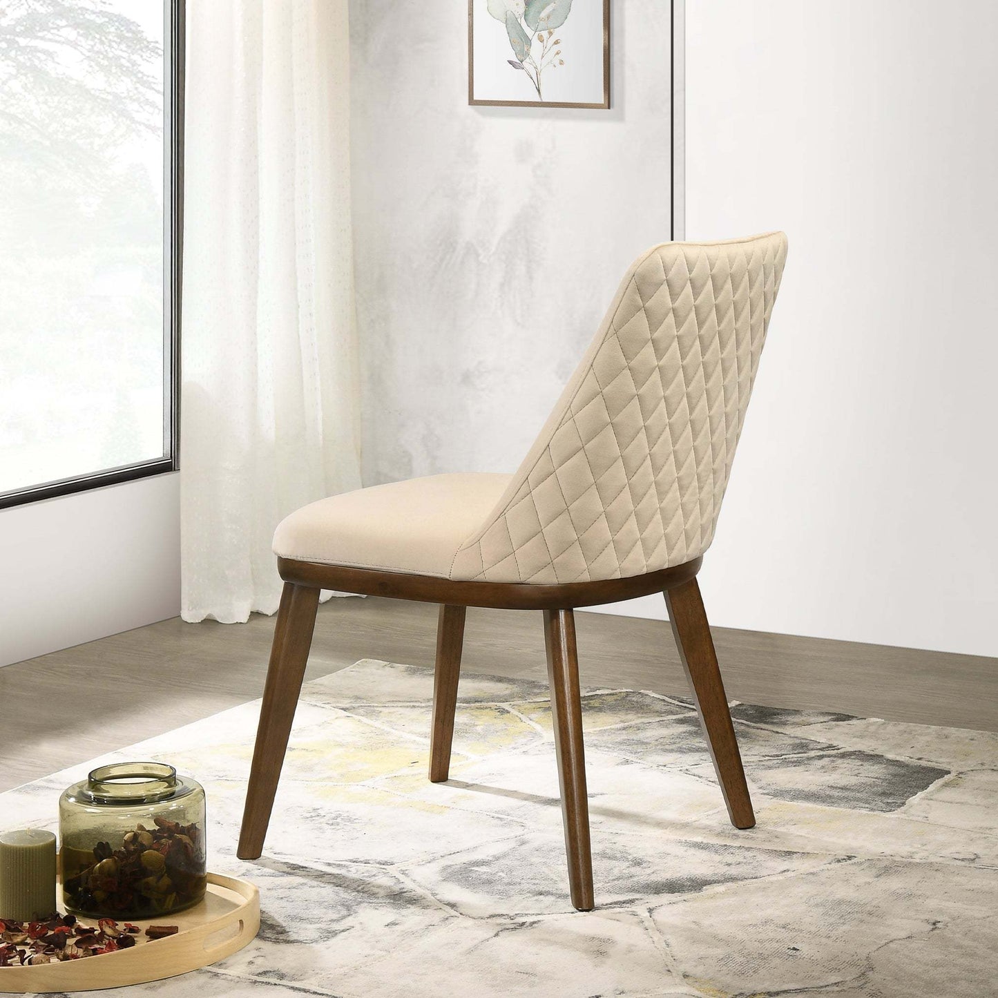Modern beige quilted accent chair with wooden legs in a bright living room, FredCo International furniture