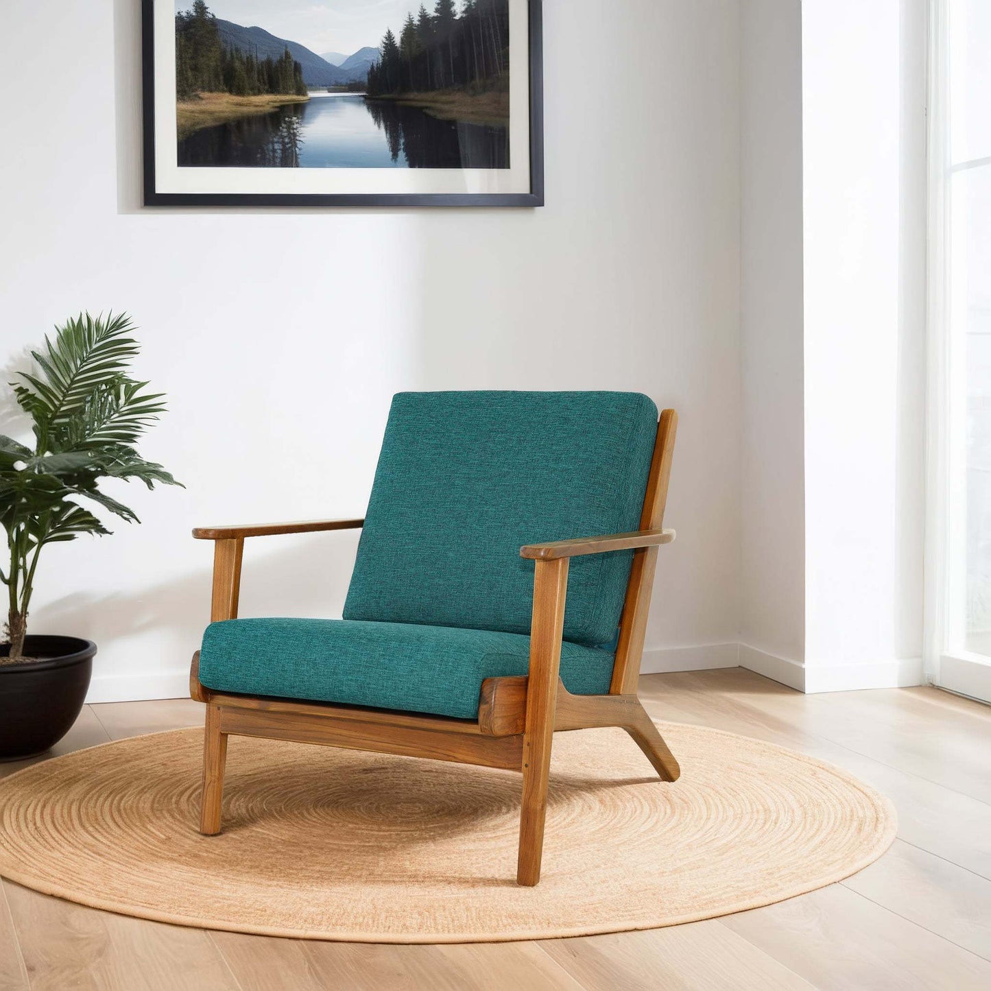 Mid-century modern teal armchair with wooden frame on round rug, in bright living room