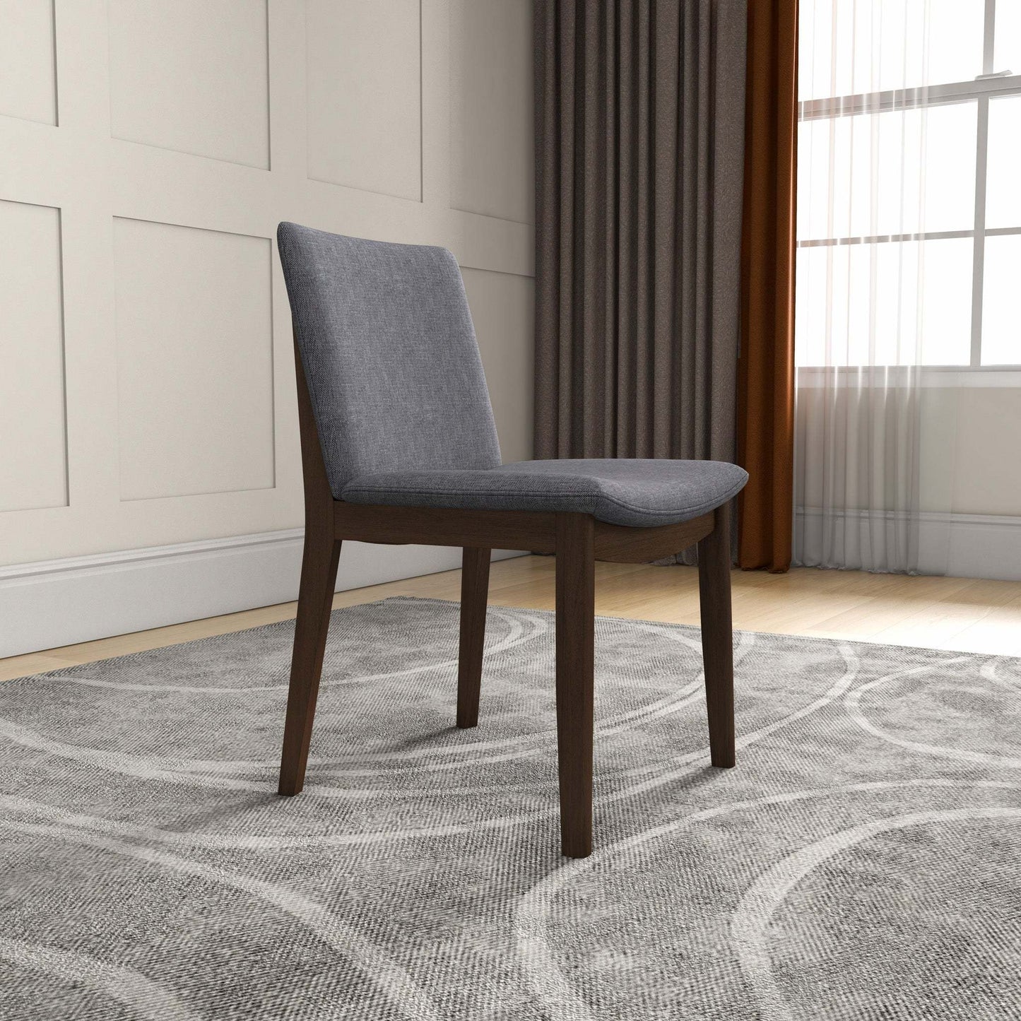 Modern gray upholstered dining chair with dark wood legs on patterned rug in stylish living room
