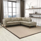 Modern beige sectional sofa in stylish living room with large windows and shelves, FredCo International furniture