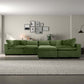 Modern living room with green sectional sofa, wall art, and FredCo International furniture decor