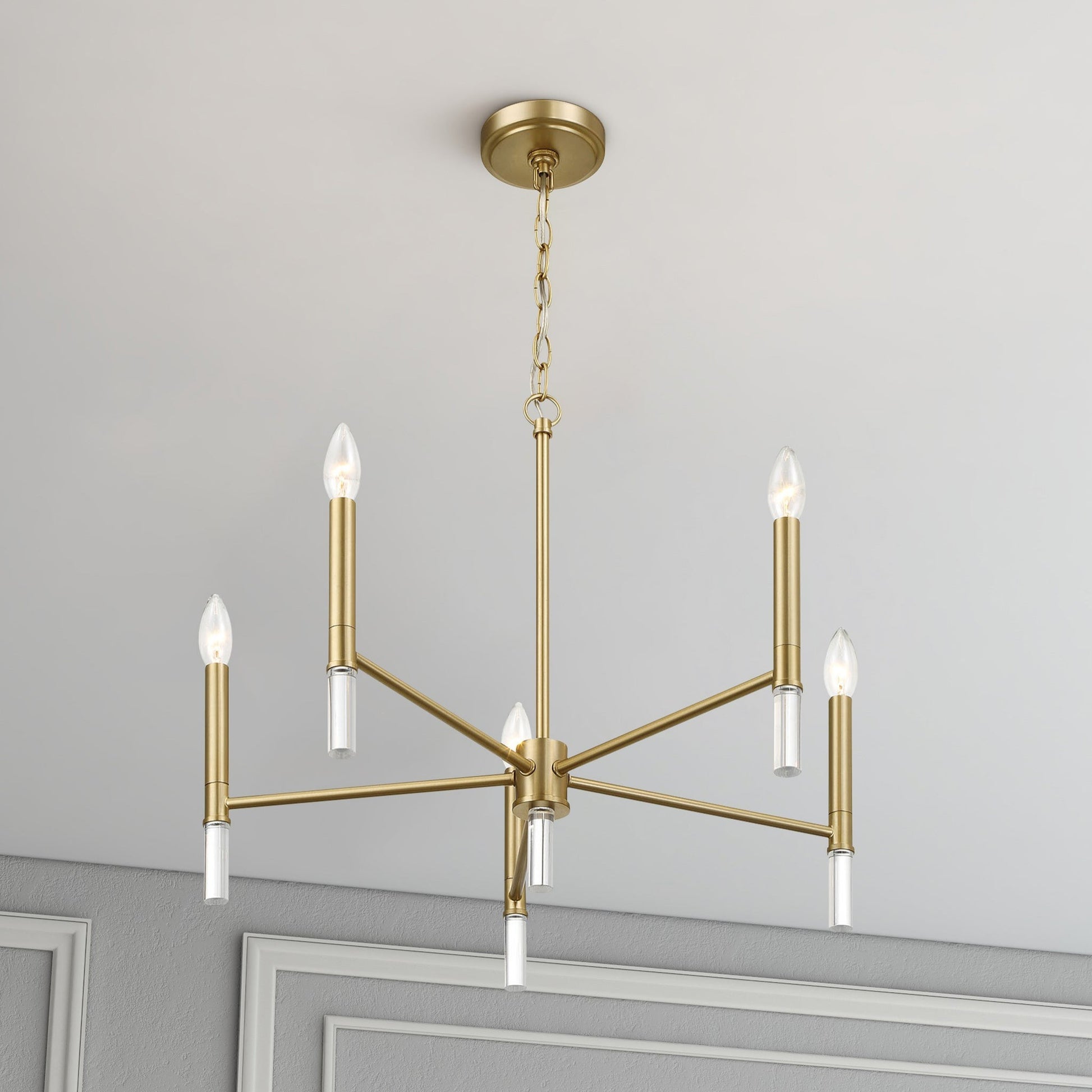 Modern gold chandelier light fixture with six bulbs in a stylish home interior ceiling