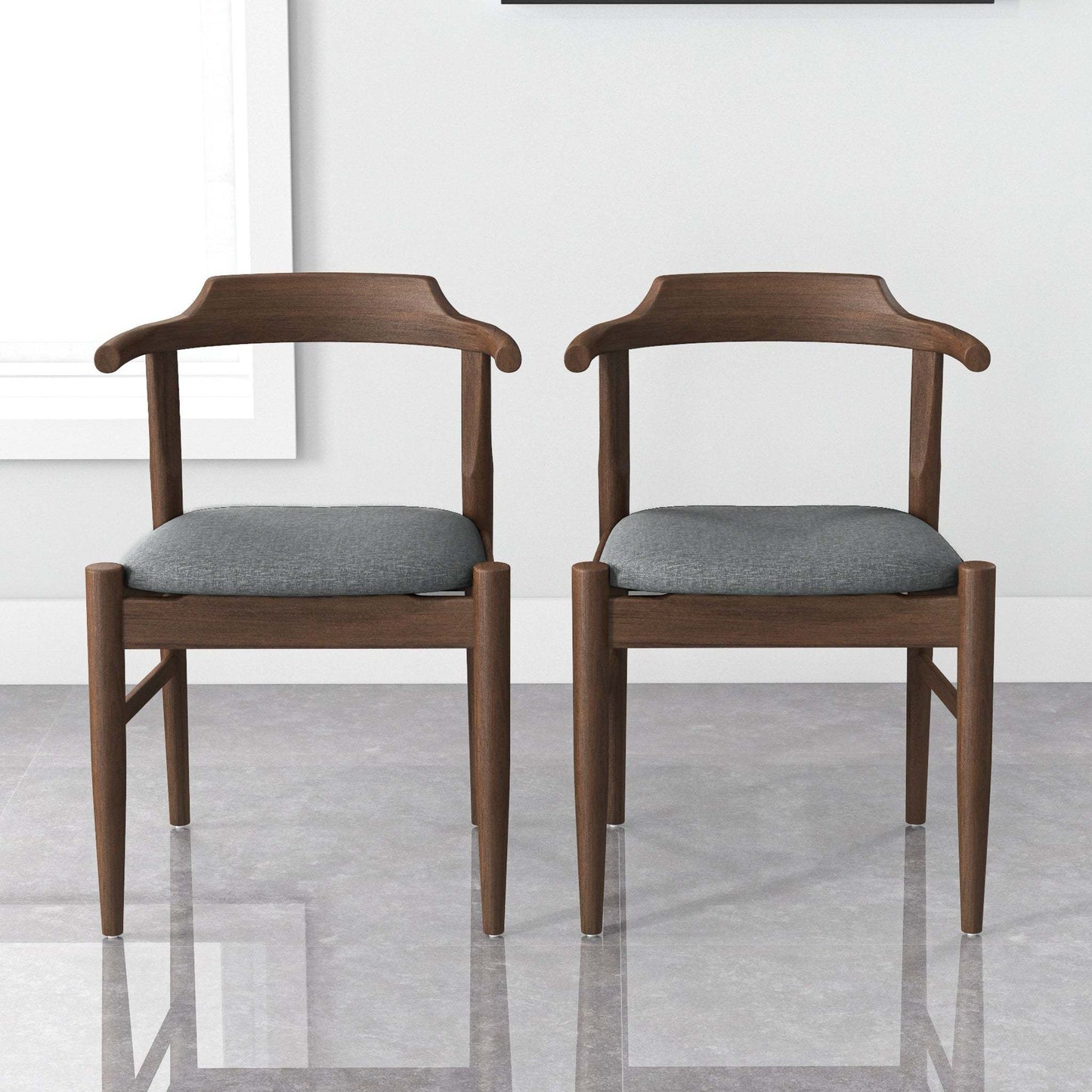Pair of modern wooden dining chairs with gray fabric seats in bright home interior