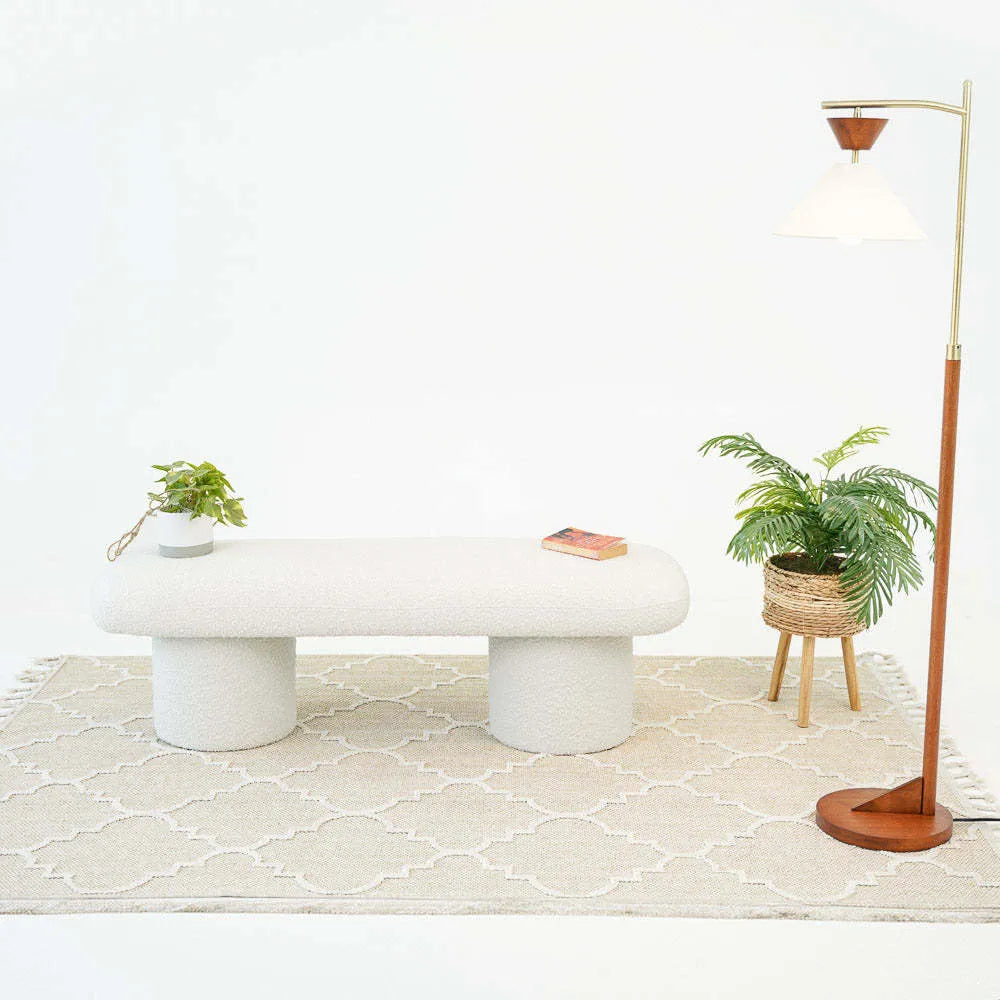 Modern white bench on beige rug with potted plants and a floor lamp, FredCo International furniture