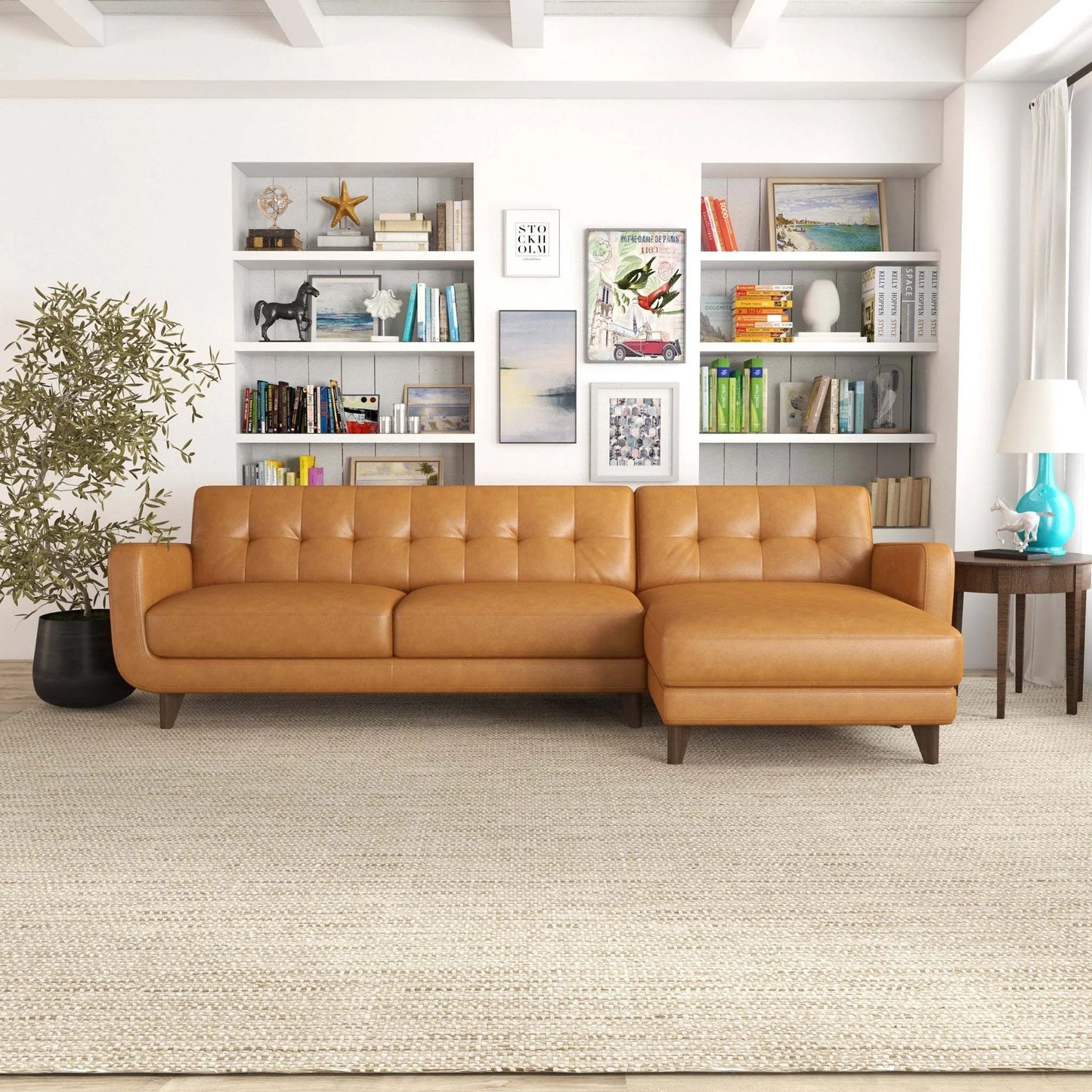 Modern tan leather sectional sofa in stylish living room with bookshelves, rug, and decor
