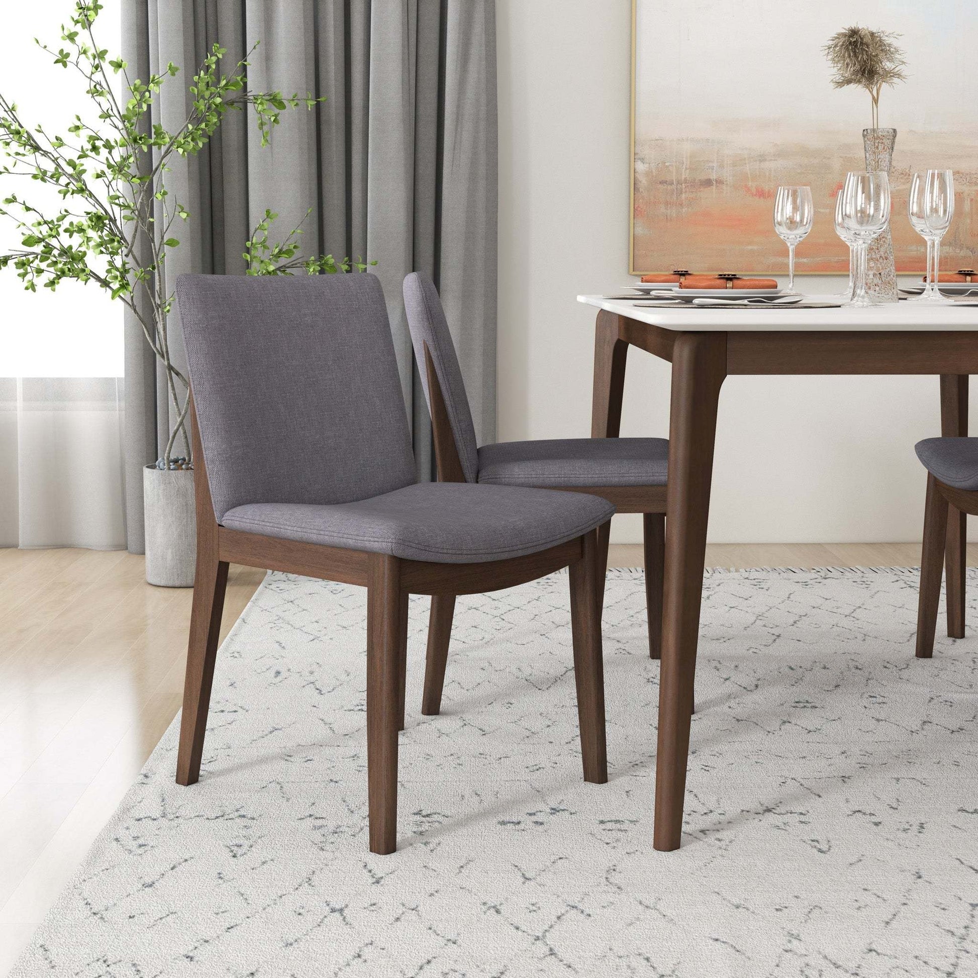 Modern dining room with gray upholstered chairs, wooden table, and elegant decor