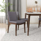Modern dining room with gray upholstered chairs, wooden table, and elegant decor