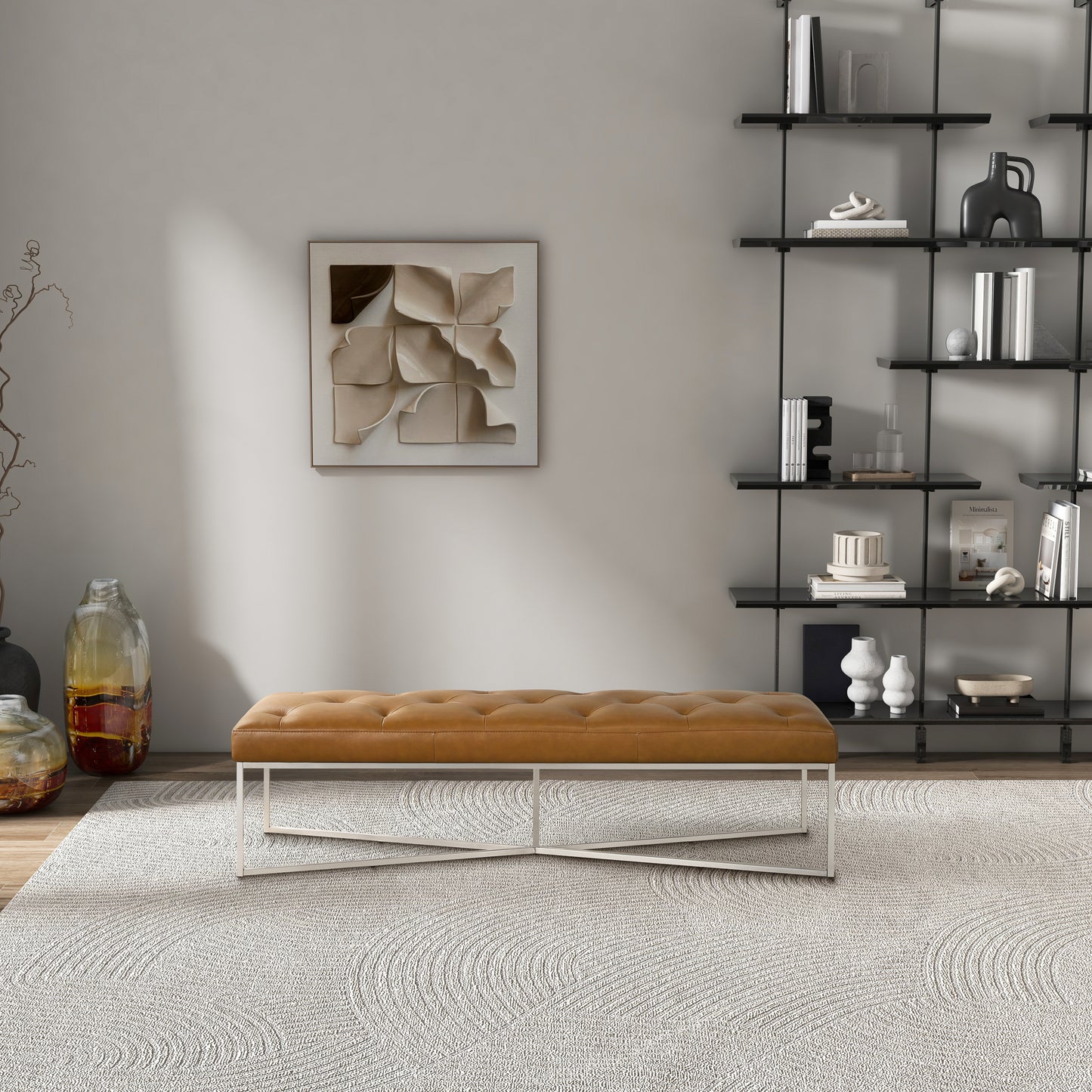 Modern living room with tan upholstered bench, minimalist wall art, and black open shelving