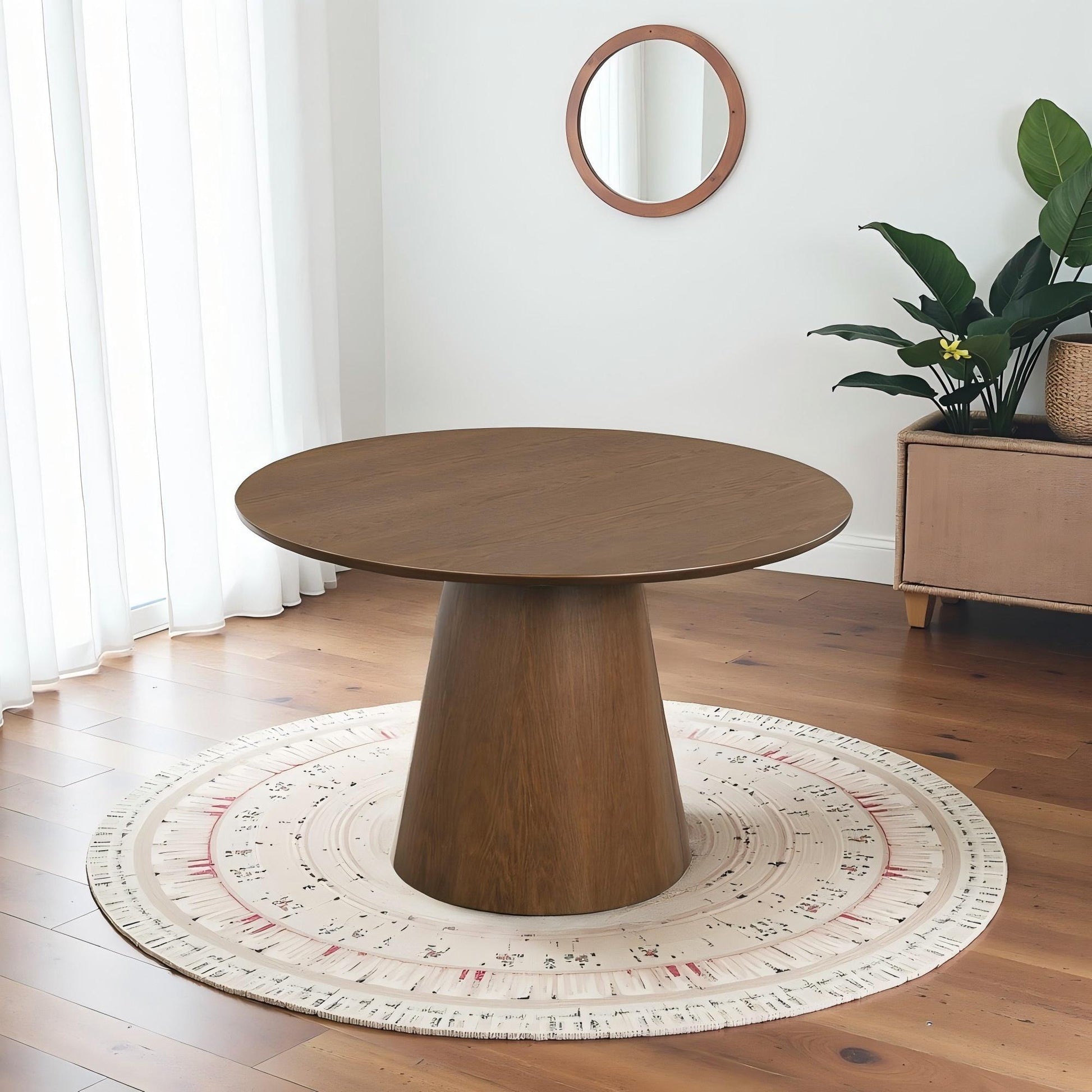 Modern round wooden dining table on patterned rug in bright living room with houseplant