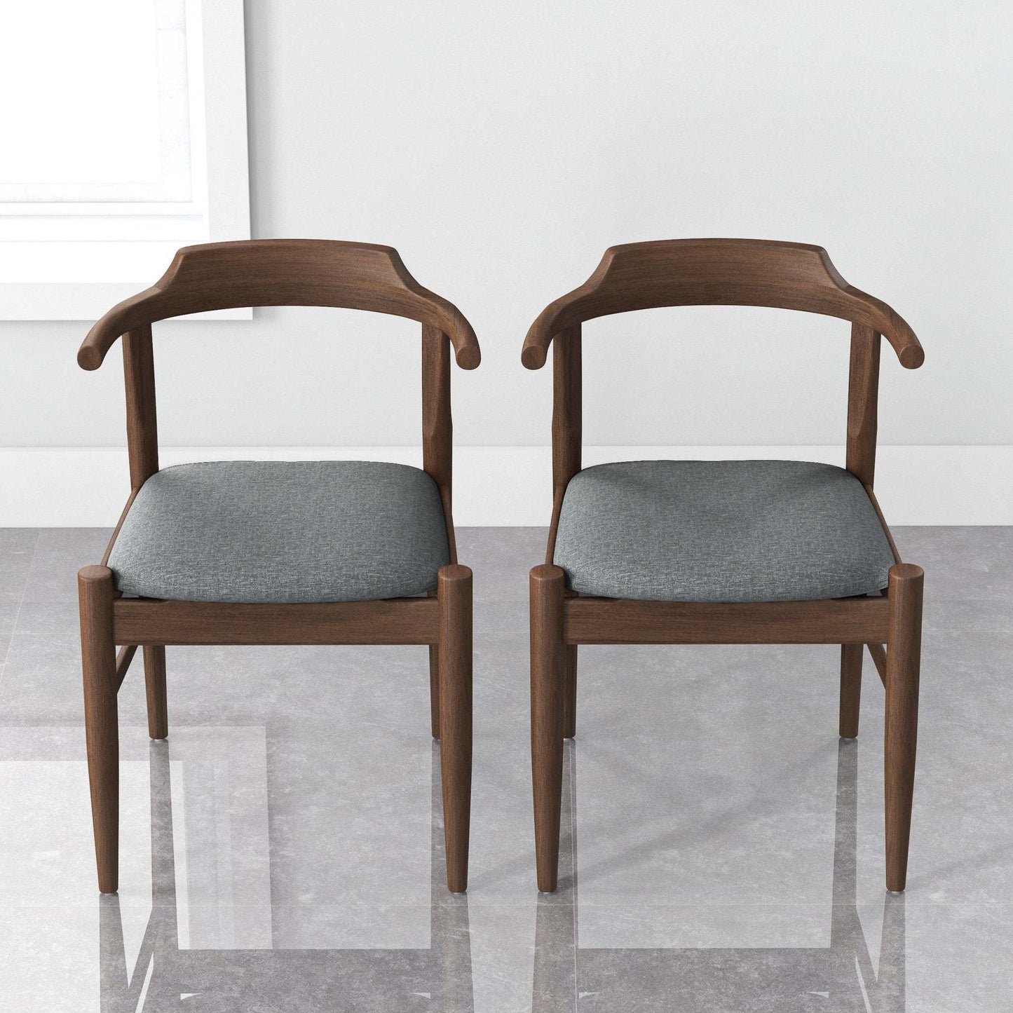 Pair of modern wooden dining chairs with gray cushions in a minimalist room