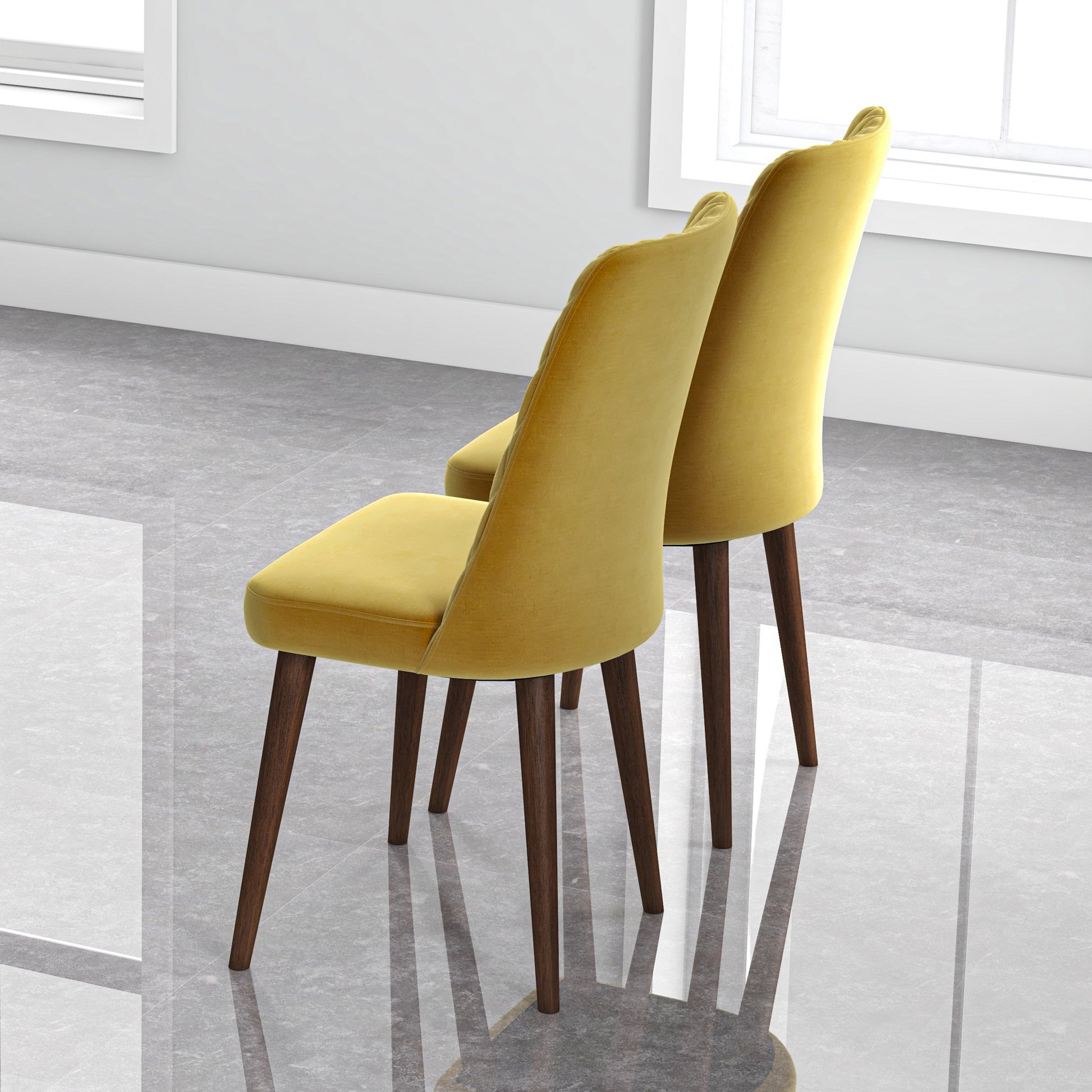 Pair of modern yellow dining chairs with wooden legs on polished floor in bright room