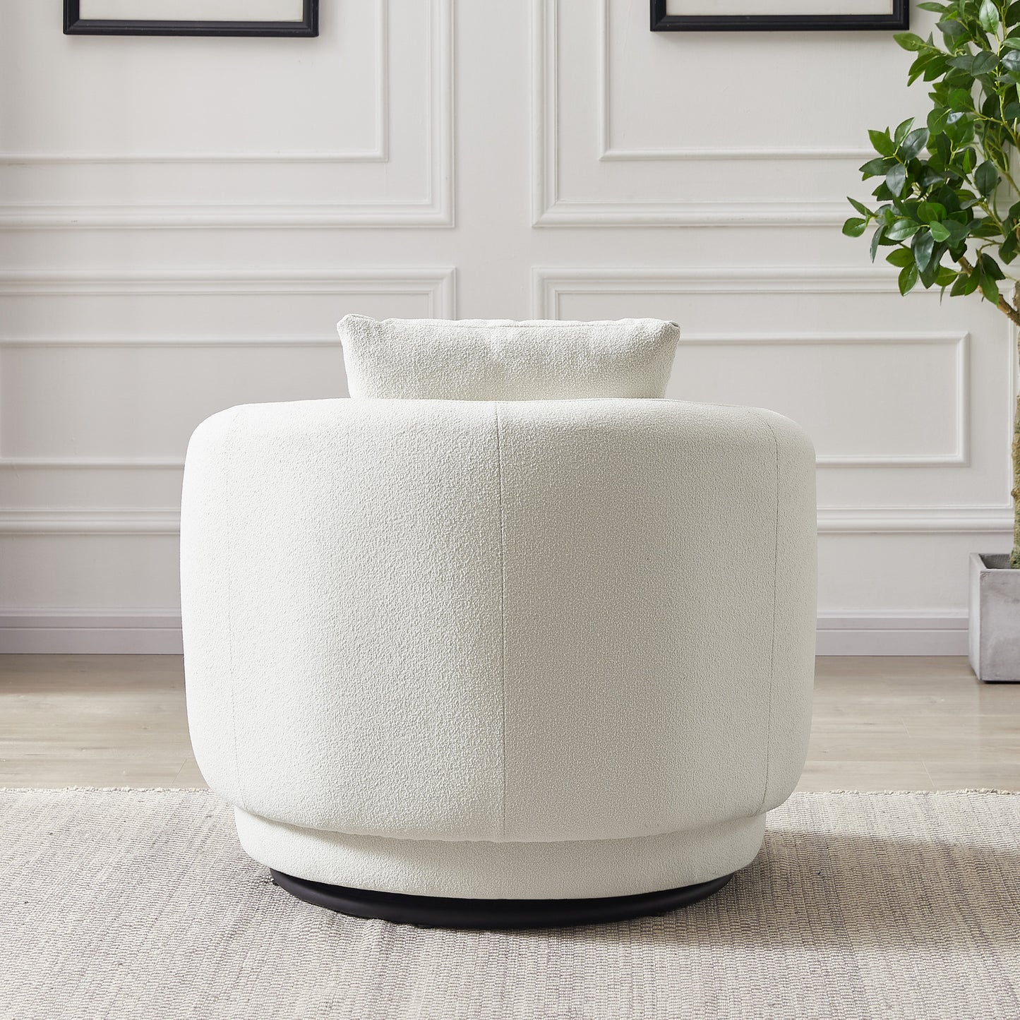 Modern white boucle swivel chair in a living room with elegant wall paneling