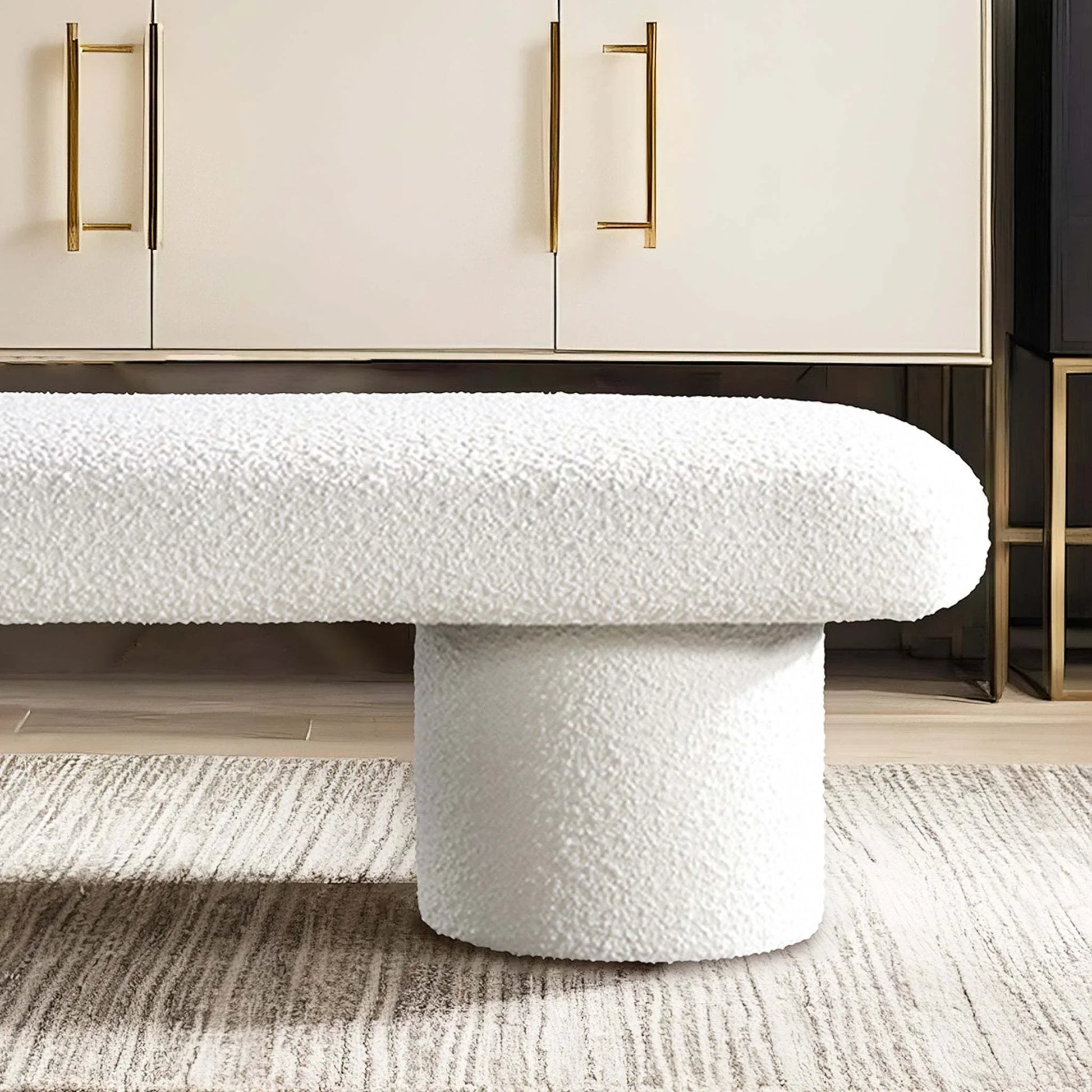 Modern white boucle bench with cylindrical base on textured rug, stylish home furniture