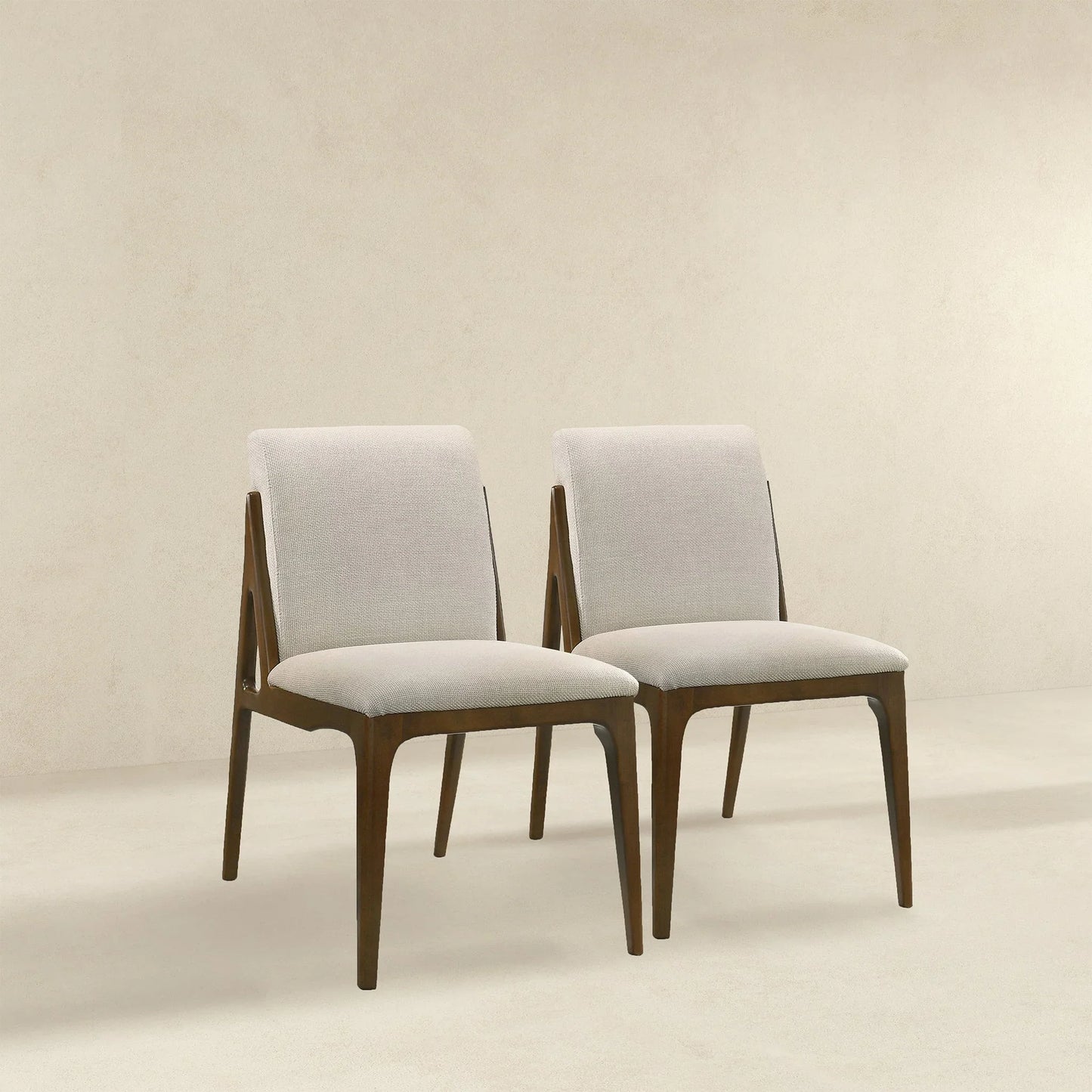 Pair of modern dining chairs with light upholstery and wooden frames, FredCo International