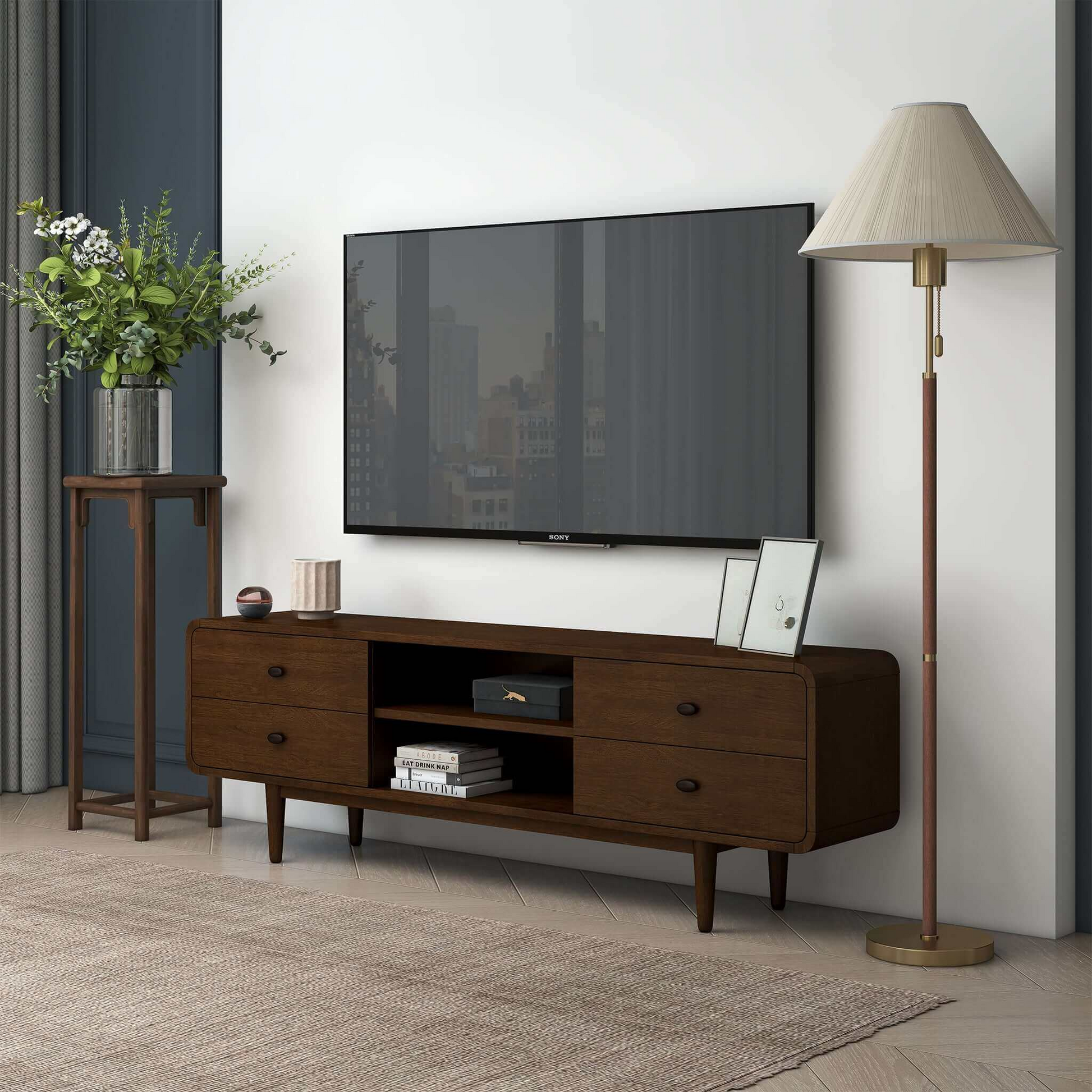 Modern living room with a dark wood TV stand, flat-screen TV, floor lamp, and plant, FredCo International furniture