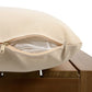 Beige cushion with zipper open, revealing interior filling, on a wooden bench