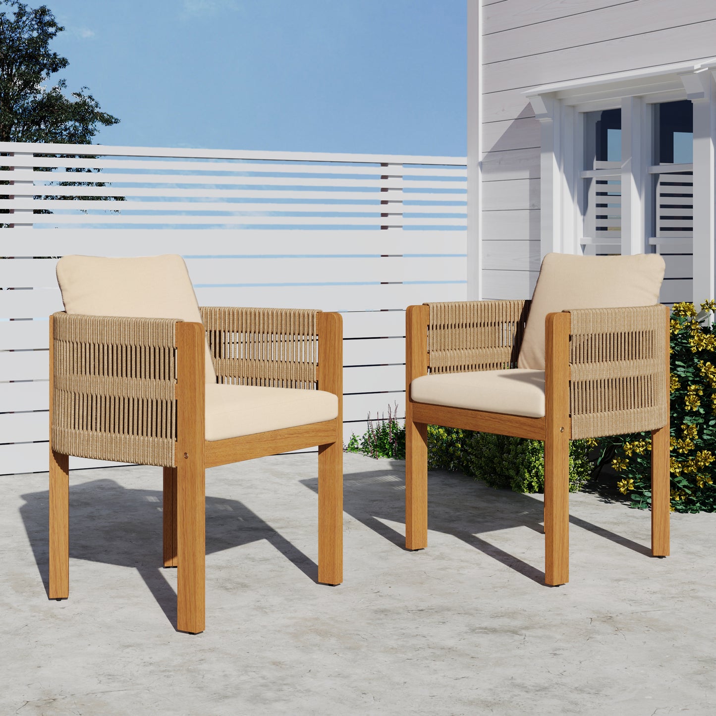 Outdoor wooden patio chairs with beige cushions on a concrete patio, FredCo International furniture
