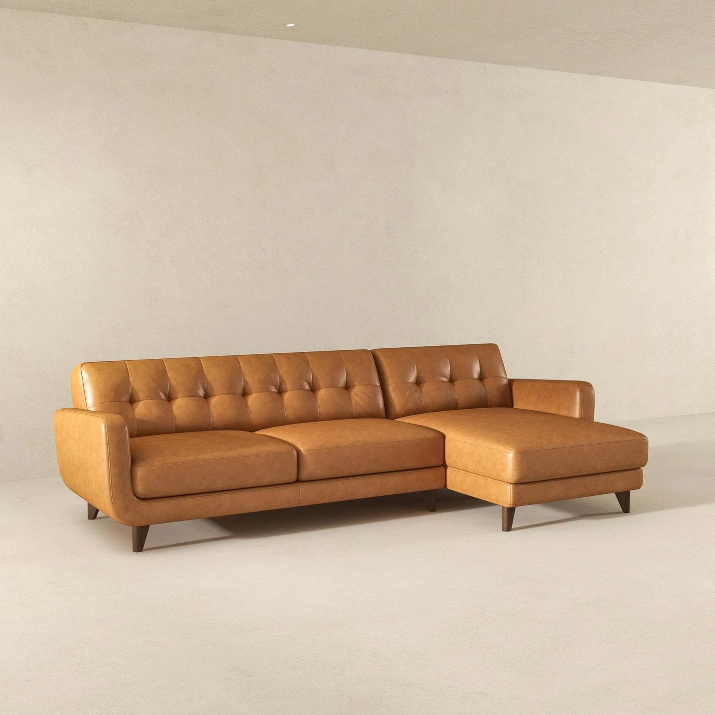 Mid-century modern tan leather sectional sofa with chaise in minimalist living room, FredCo International furniture