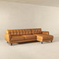 Mid-century modern tan leather sectional sofa with chaise in minimalist living room, FredCo International furniture