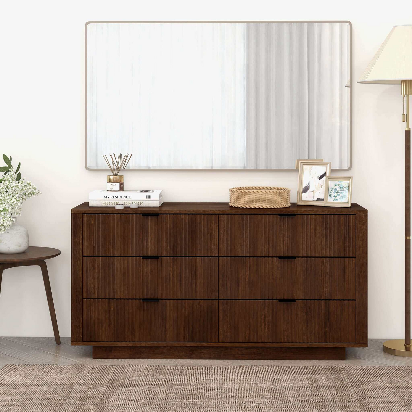 Modern wood dresser with decor accents and large mirror in stylish home setting