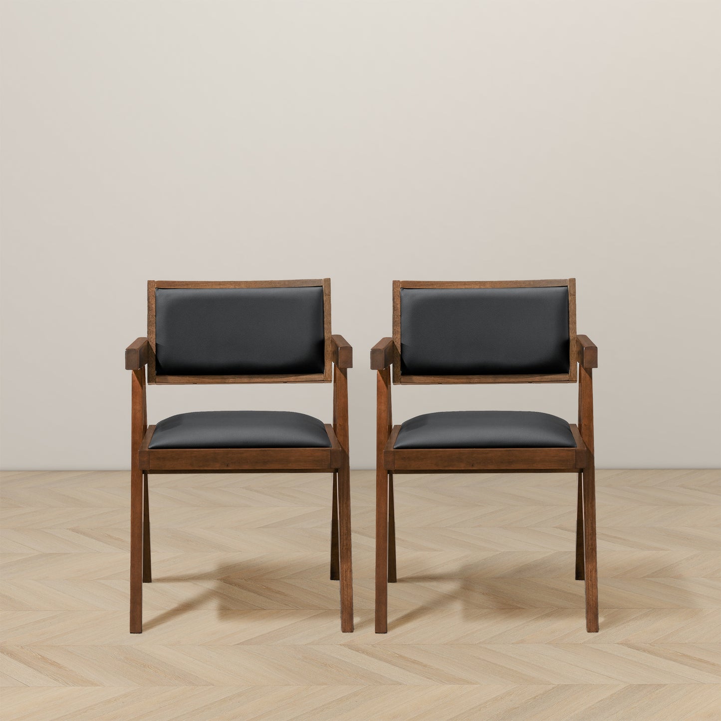 Pair of modern wood dining chairs with black cushions on light wood floor, FredCo International
