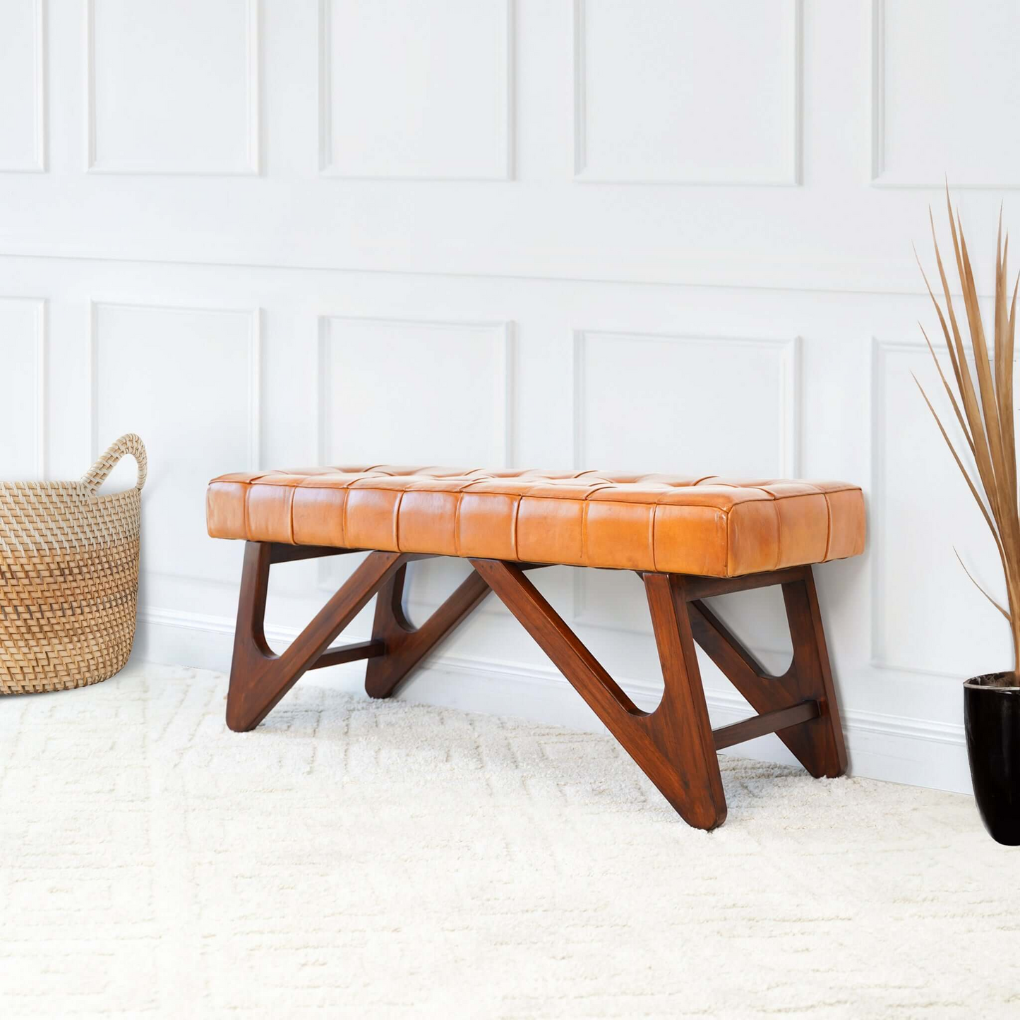Mid-century modern leather bench with wood legs in bright living room, FredCo International furniture