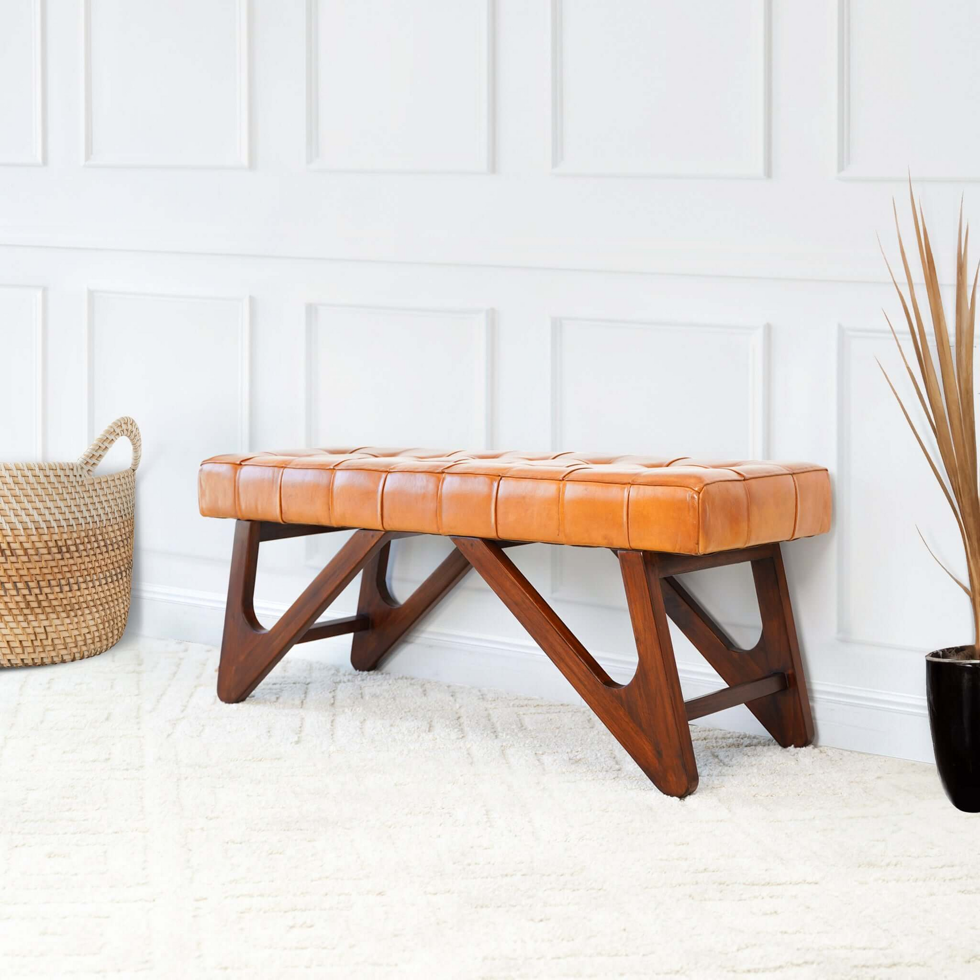 Mid-century modern leather bench with wood legs in bright living room, FredCo International furniture