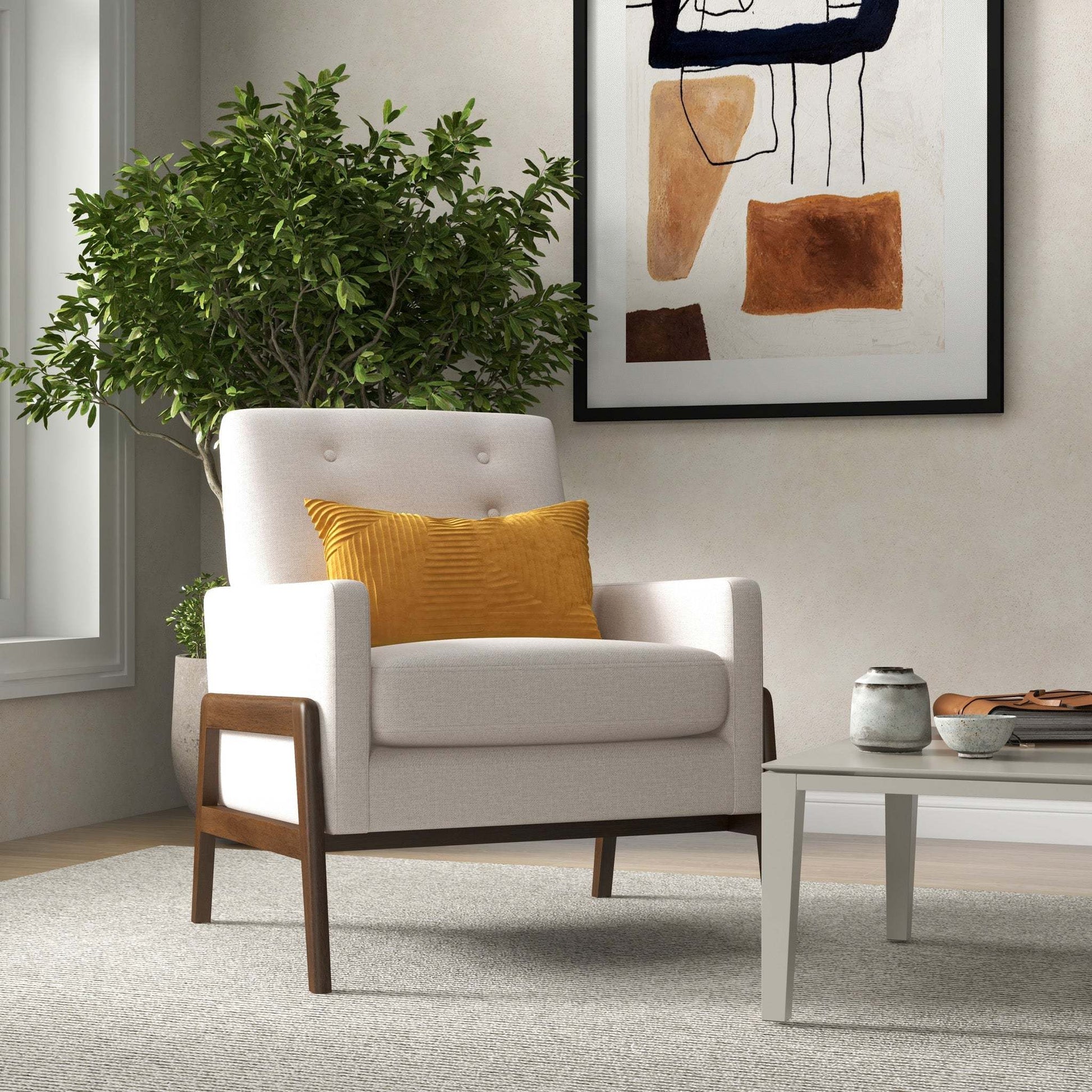Modern living room with a beige armchair, yellow pillow, potted plant, and abstract wall art.