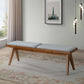 Mid-century modern wood bench with gray cushion in a bright living room, FredCo International furniture