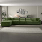 Modern living room with green sectional sofa, framed art, and neutral decor from FredCo International
