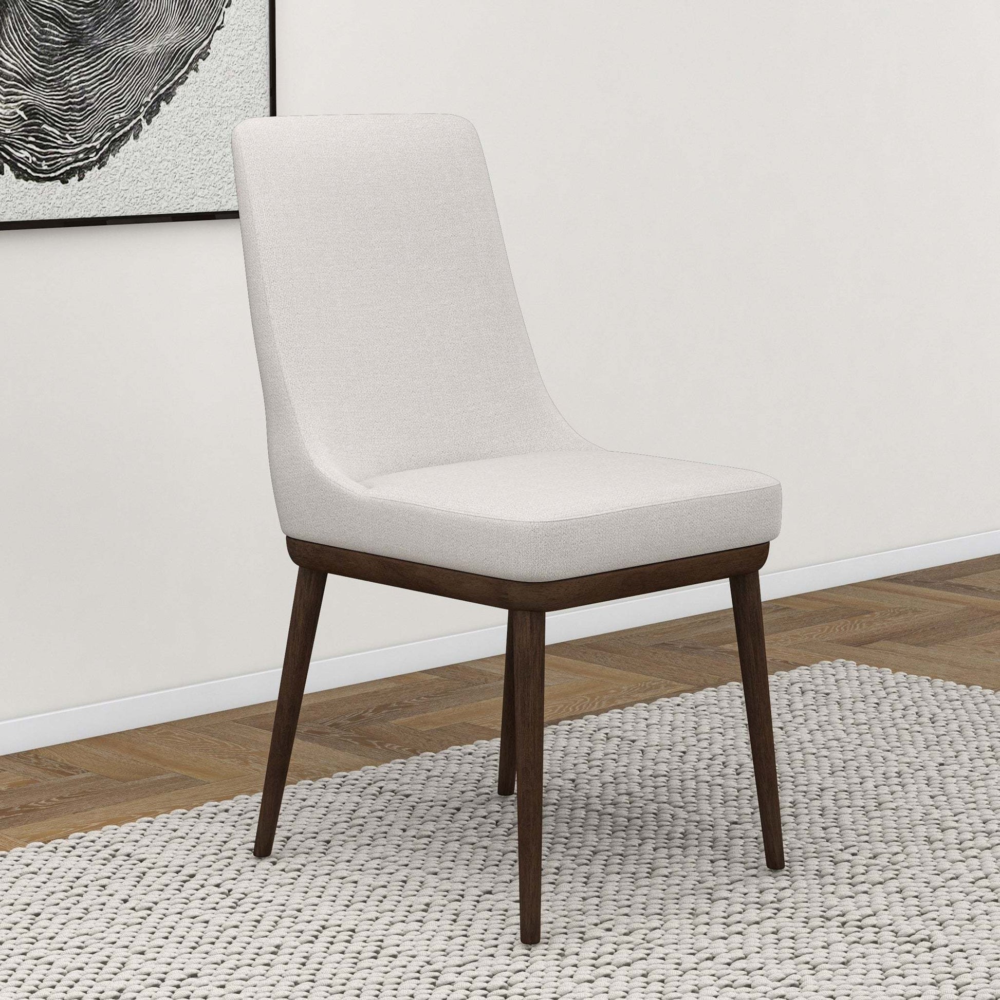 Modern upholstered dining chair with dark wood legs on textured rug, FredCo International furniture