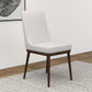 Modern upholstered dining chair with dark wood legs on textured rug, FredCo International furniture