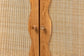 Close-up of wooden cabinet doors with woven rattan panels and stylish handles