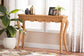 Wicker console table in bright living room with lamp, plant, and decor accents from FredCo International