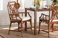 Rattan dining chairs with beige cushions and wooden table in a bright home setting