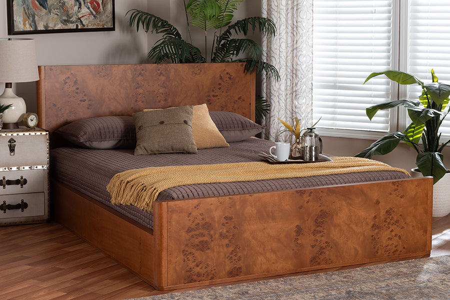 Modern wood bed with brown bedding, accent pillows, and cozy decor in a sunlit bedroom