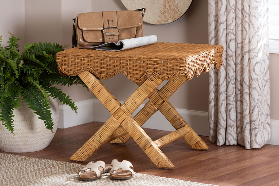Wicker accent table with crossed legs in a cozy room, styled with a purse, magazine, and houseplant